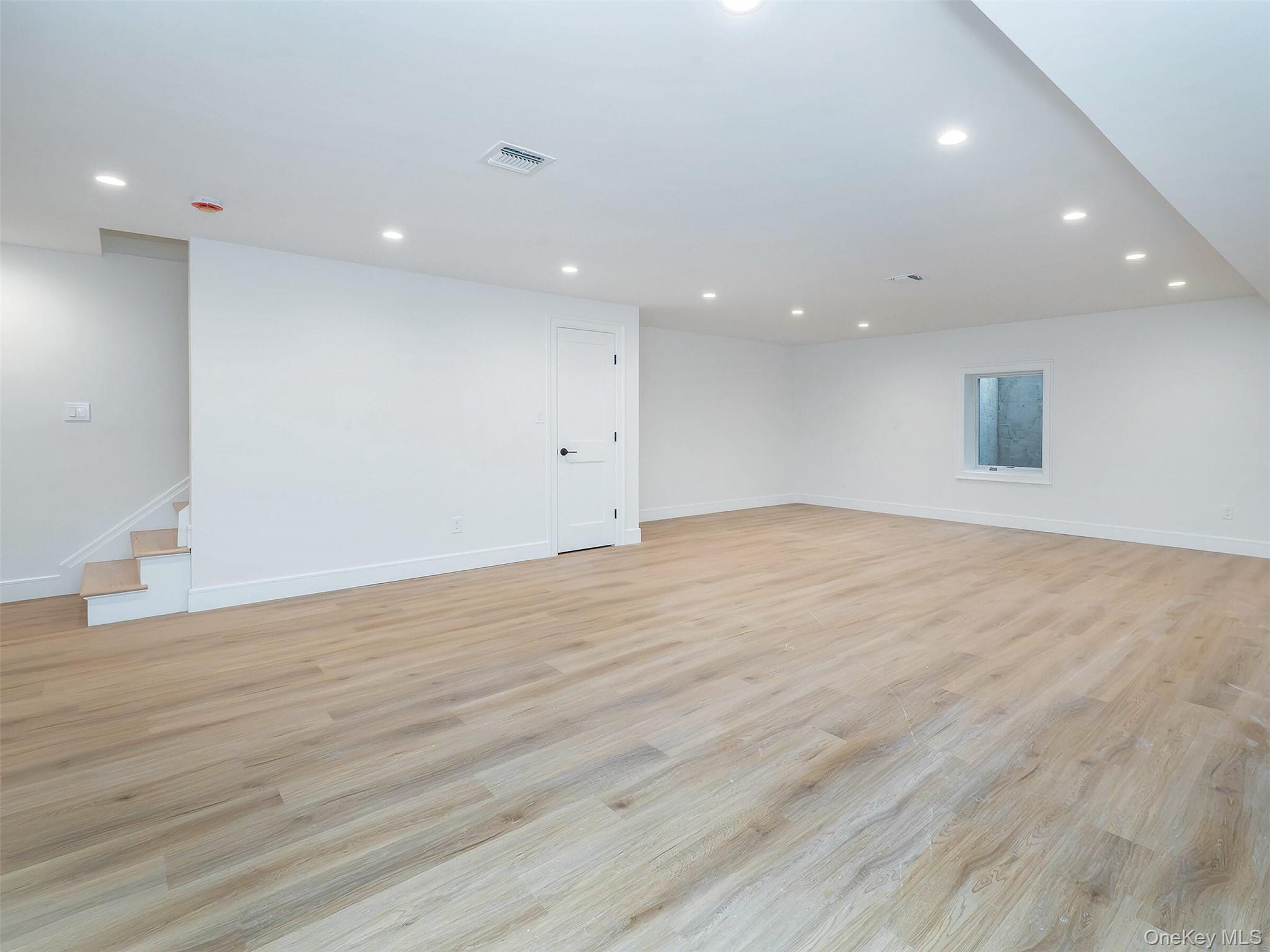 35 B Dunwood Road Port Washington, NY 11050 - Photo 27 of 35 an empty room with wooden floor and entrance