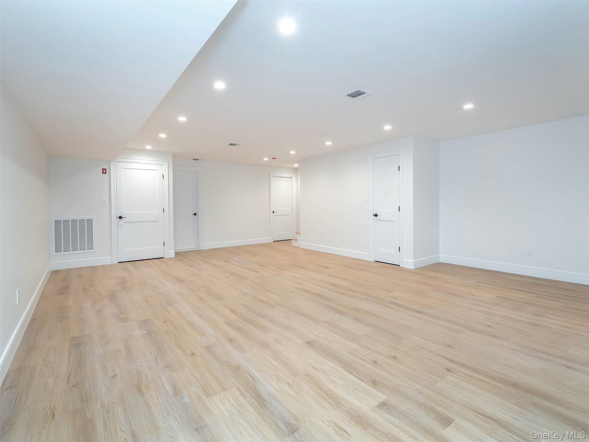 35 B Dunwood Road Port Washington, NY 11050 - Photo 29 of 35 a view of an empty room with wooden floor