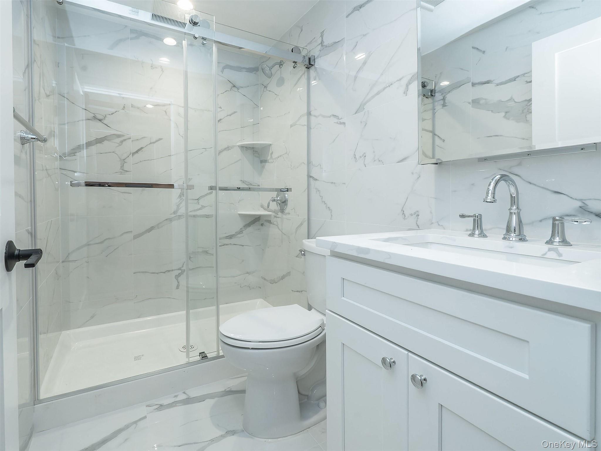 35 B Dunwood Road Port Washington, NY 11050 - Photo 30 of 35 a bathroom with a sink toilet and shower