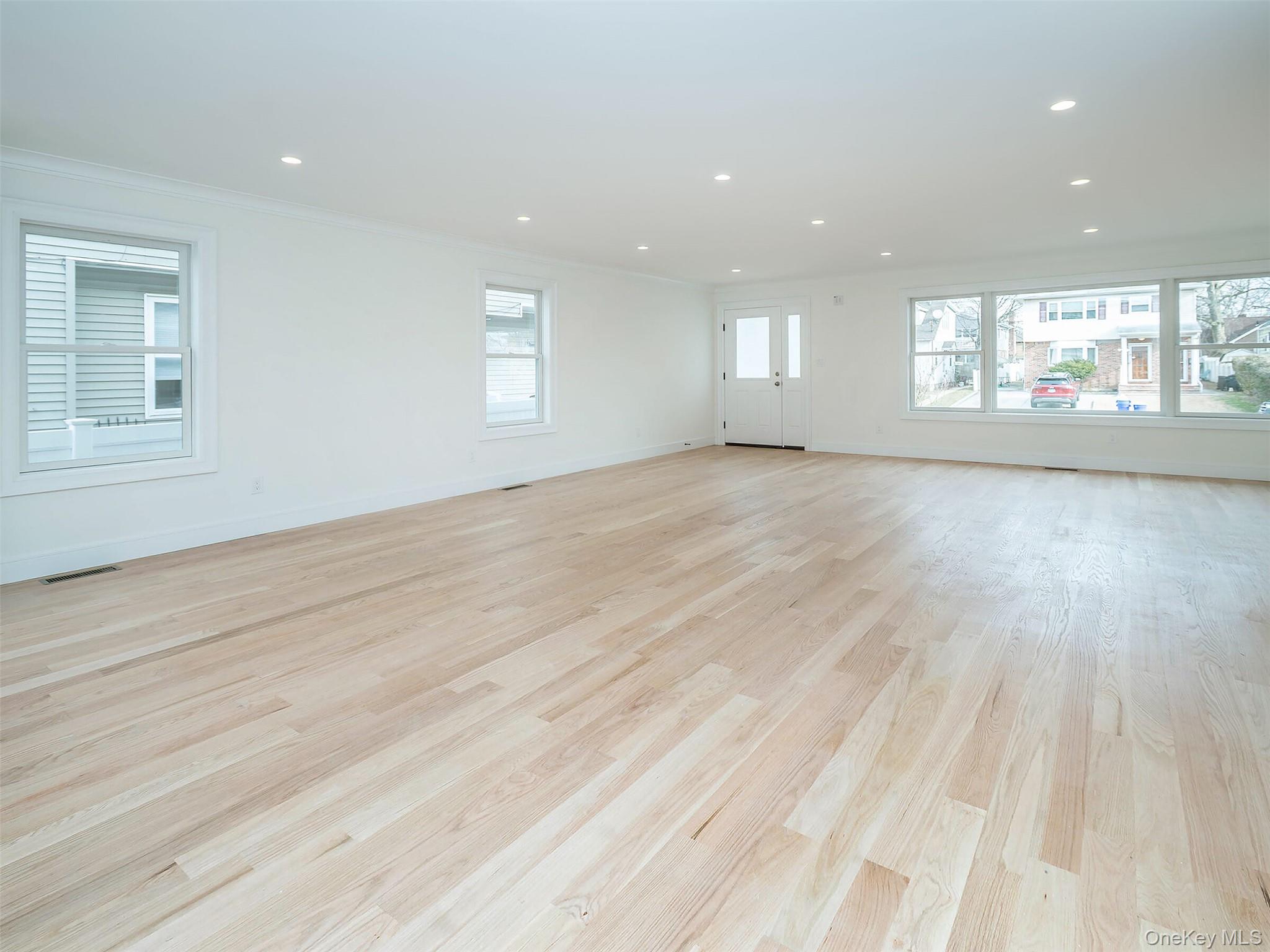 35 B Dunwood Road Port Washington, NY 11050 - Photo 3 of 35 an empty room with wooden floor and windows