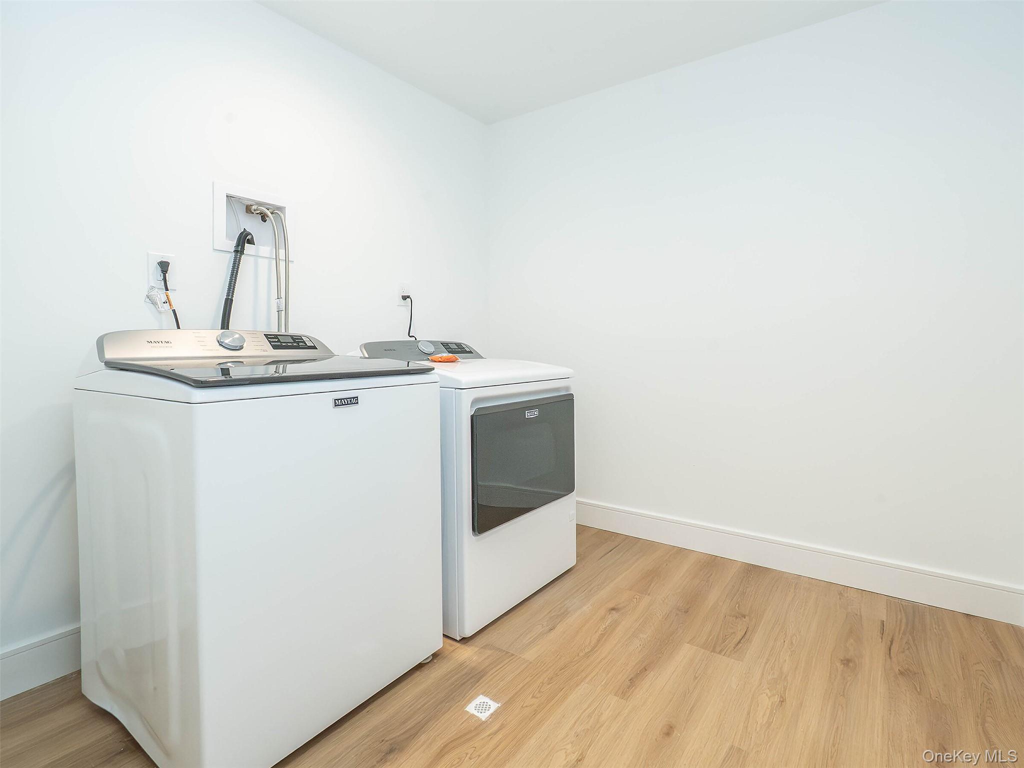 35 B Dunwood Road Port Washington, NY 11050 - Photo 31 of 35 a utility room with a sink washer and dryer
