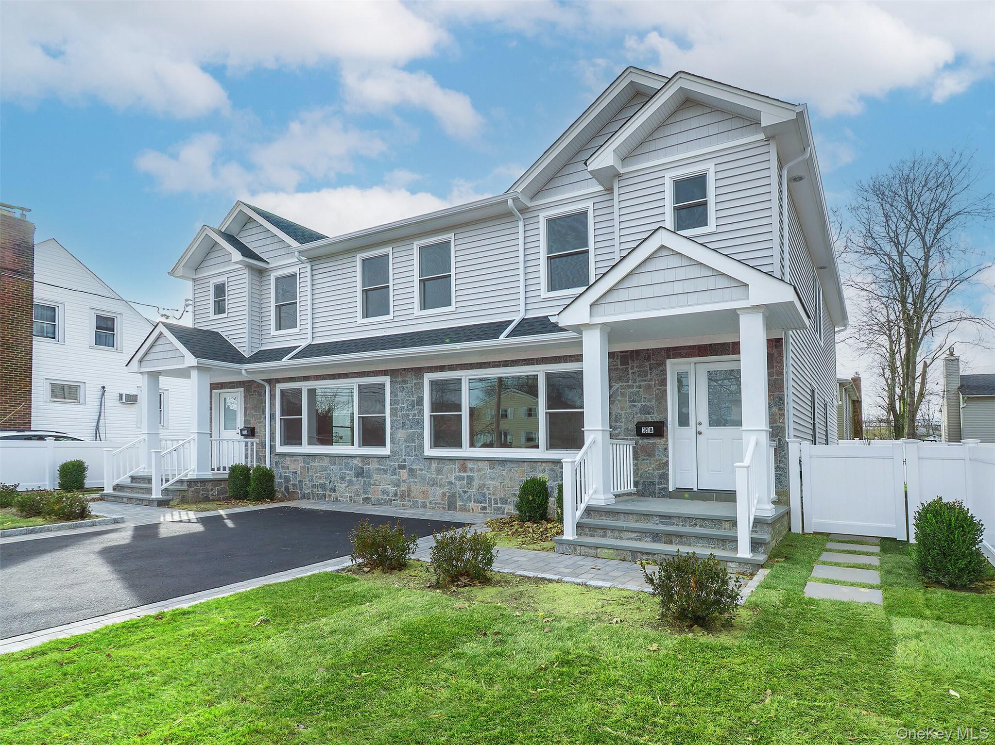 35 B Dunwood Road Port Washington, NY 11050 - Photo 35 of 35 a front view of a house with a yard and outdoor seating