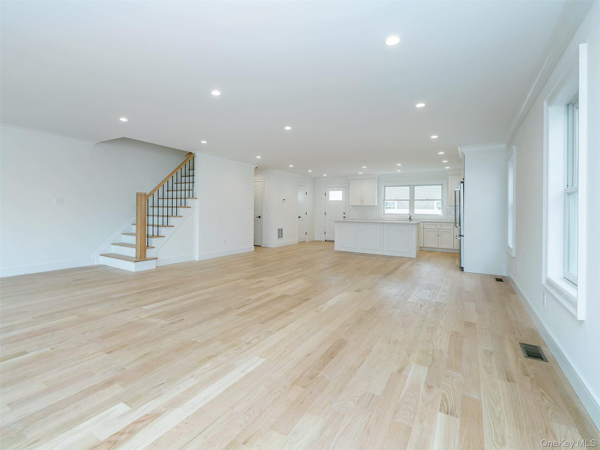 35 B Dunwood Road Port Washington, NY 11050 - Photo 6 of 35 an empty room with wooden floor and windows