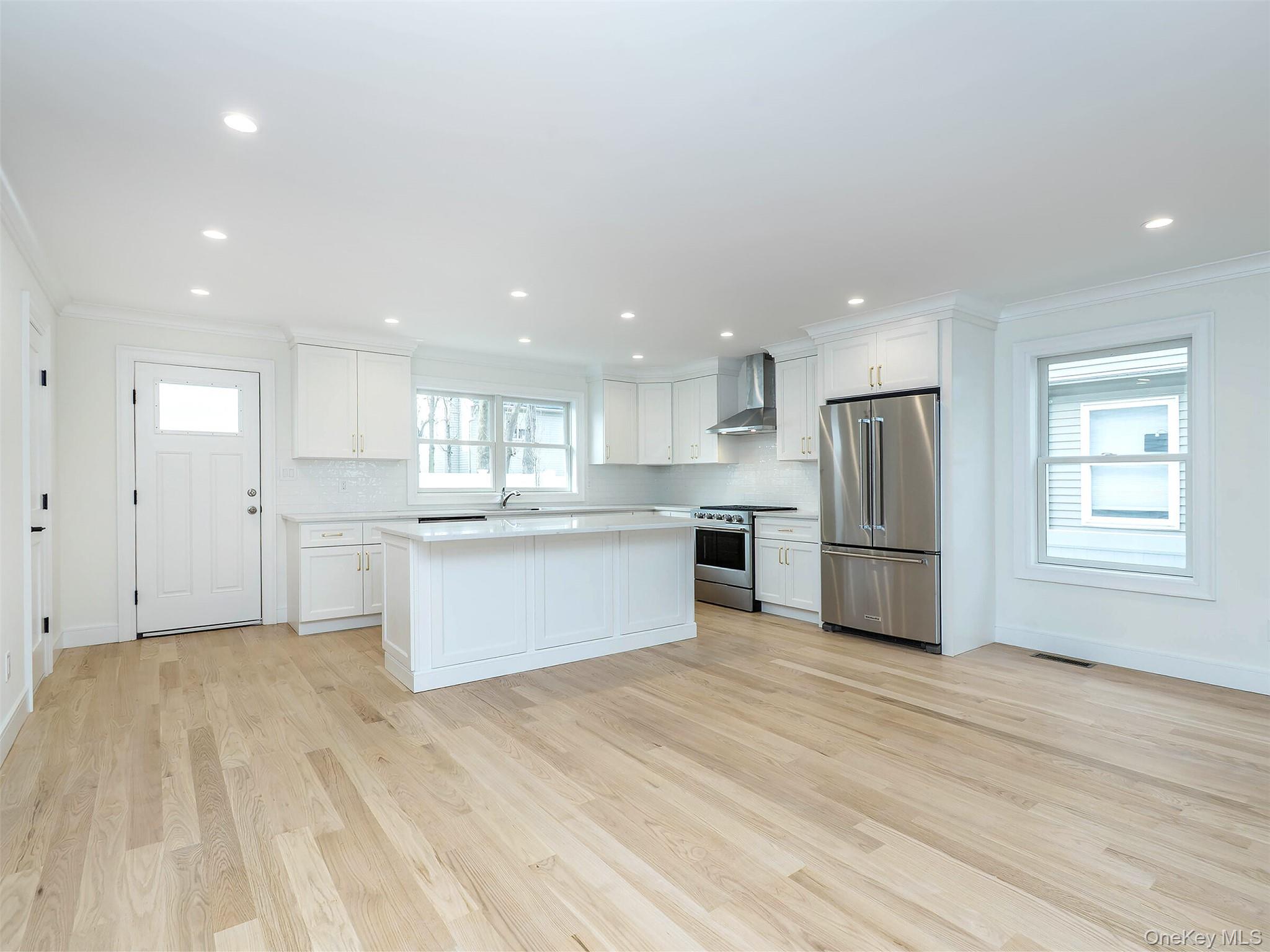 35 B Dunwood Road Port Washington, NY 11050 - Photo 7 of 35 a kitchen with stainless steel appliances kitchen island a refrigerator sink and white cabinets