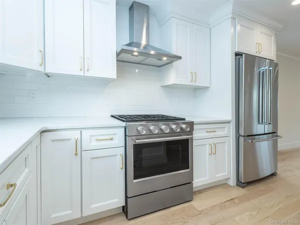 a kitchen with white cabinets and white appliances