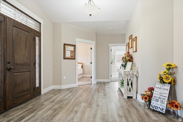 3123 East Riverdale Road Preston, ID 83263 - Photo 3 of 52 Entryway featuring wood-finish flooring, a solid wood entry door with sidelights, and a transom window with leaded glass details