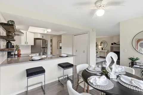 a kitchen with a dining table and chairs