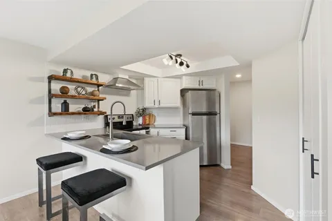 a kitchen with stainless steel appliances granite countertop a sink and refrigerator