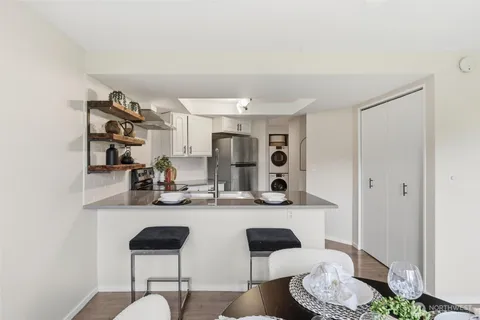 a dining room with furniture and wooden floor