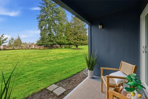 a backyard of a house with table and chairs