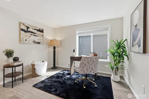 a view of room with furniture and wooden floor