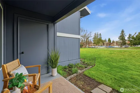 a view of front door of house with a yard