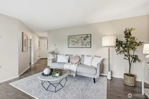 a living room with furniture and a potted plant