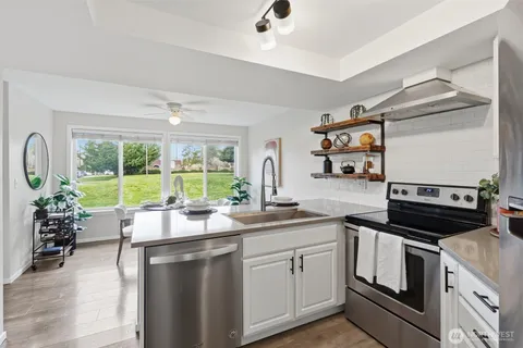 a kitchen with a sink stove and cabinets