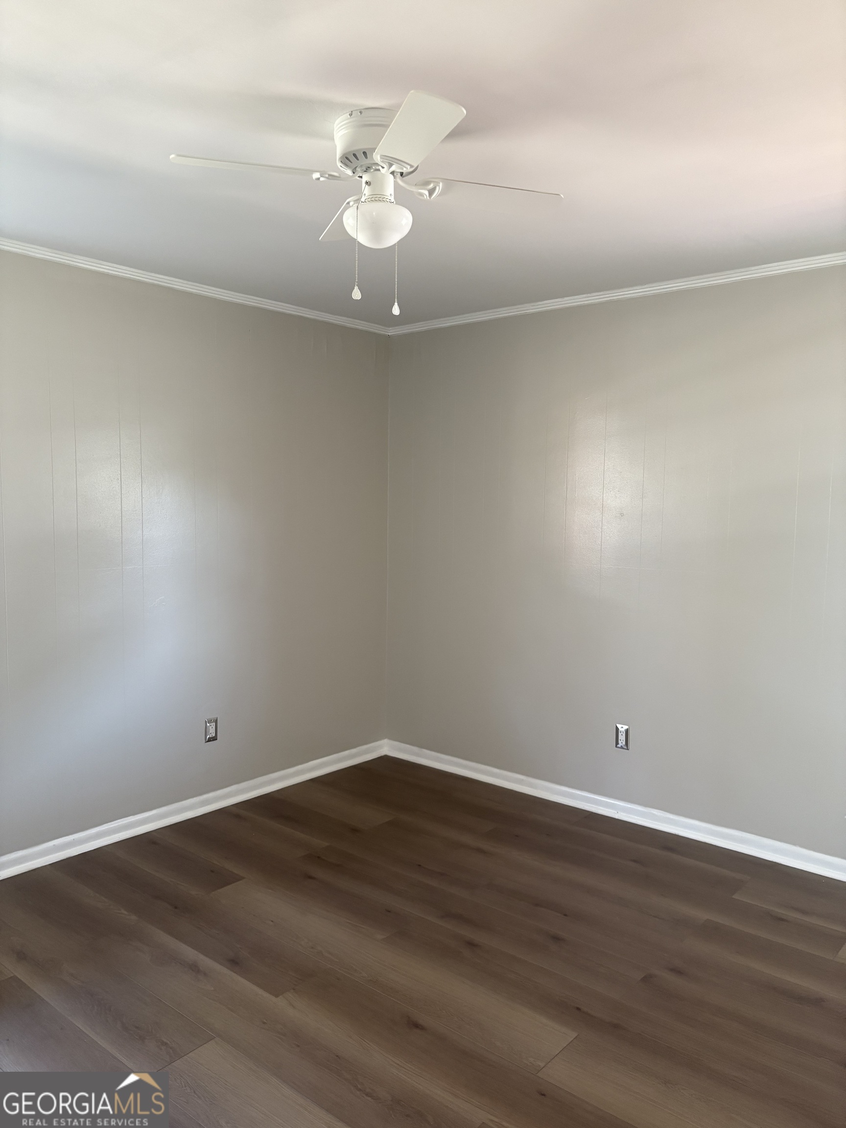 174 Main Street Rocky Ford, GA 30455 - Photo 2 of 8 a view of an empty room with wooden floor