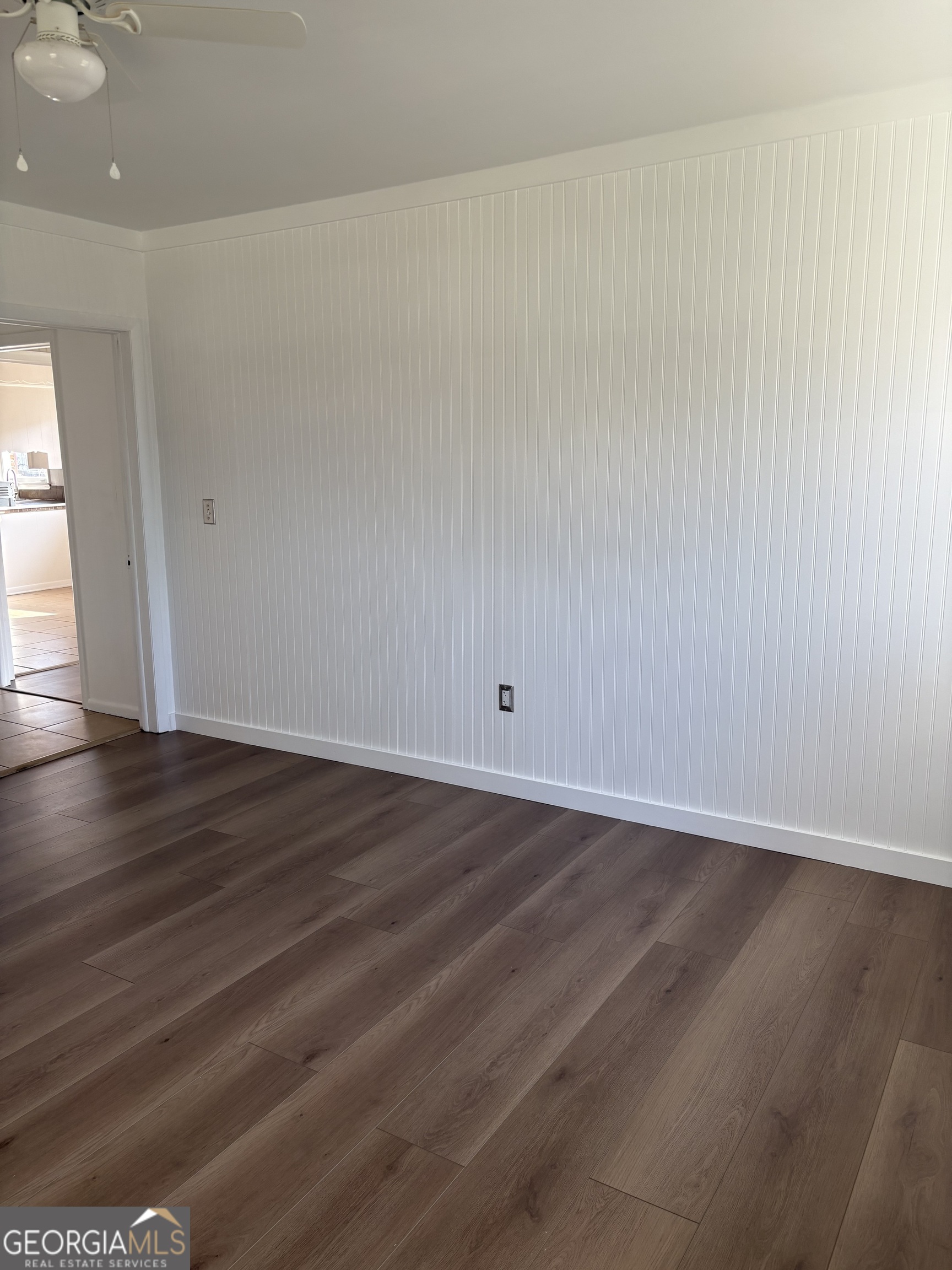 174 Main Street Rocky Ford, GA 30455 - Photo 3 of 8 a view of an empty room with wooden floor and a window