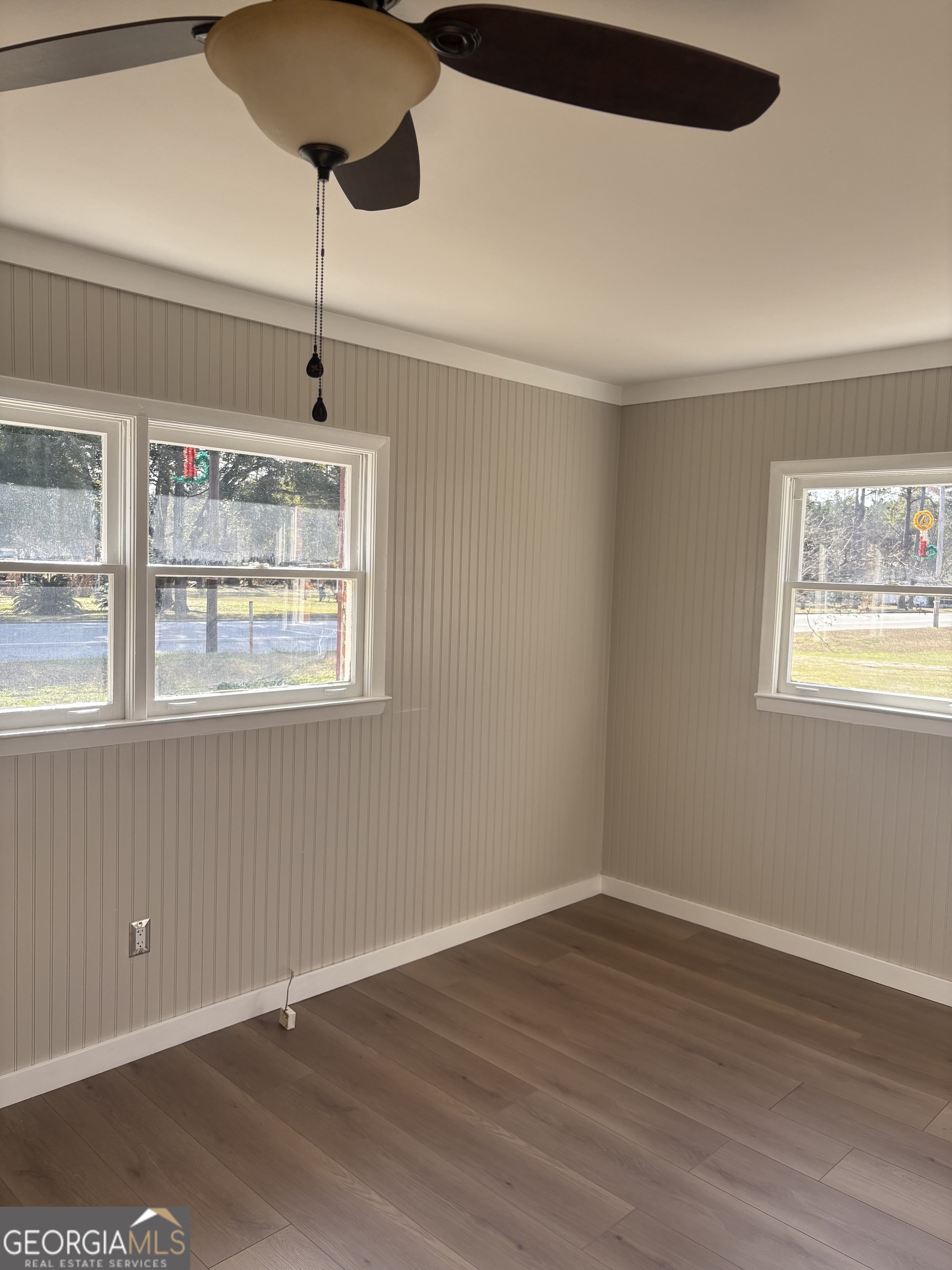 174 Main Street Rocky Ford, GA 30455 - Photo 4 of 8 a view of an empty room with wooden floor and a window