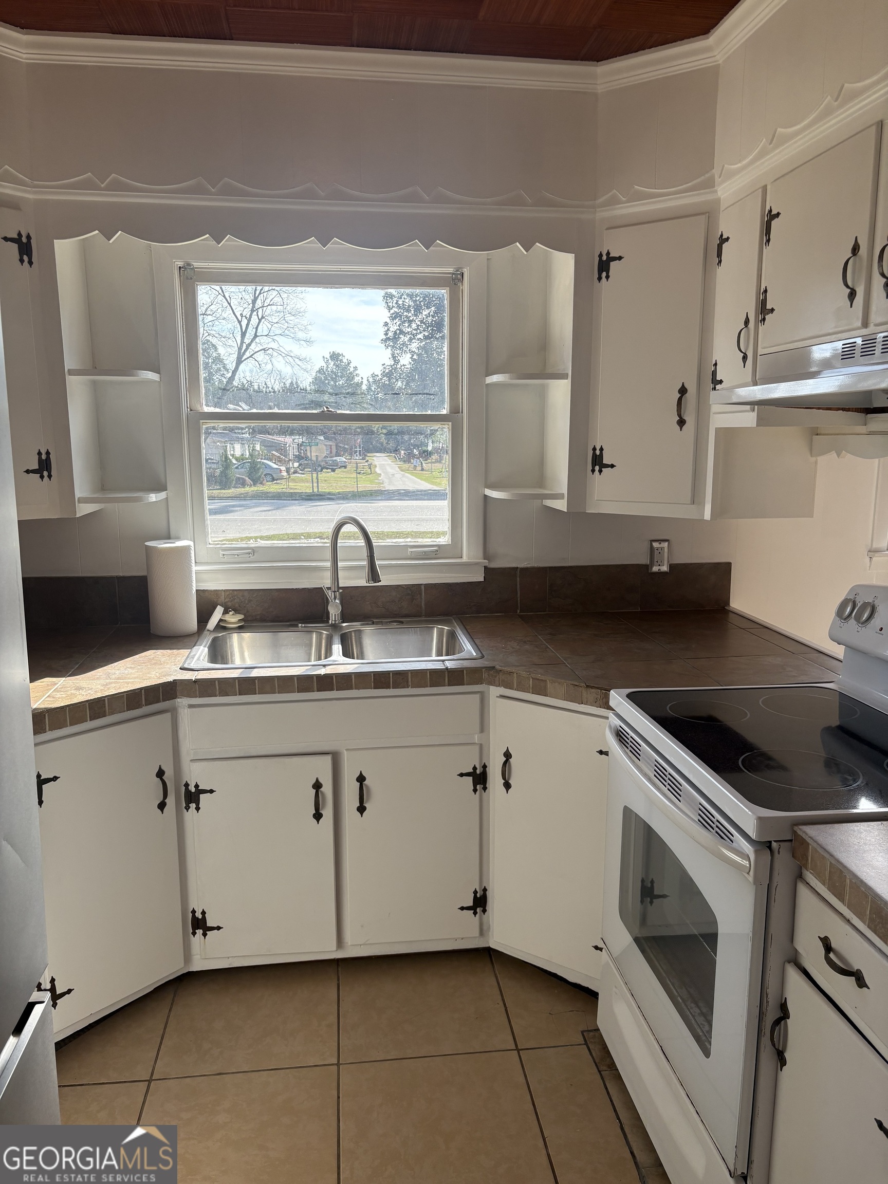 174 Main Street Rocky Ford, GA 30455 - Photo 6 of 8 a kitchen with granite countertop white cabinets and a sink