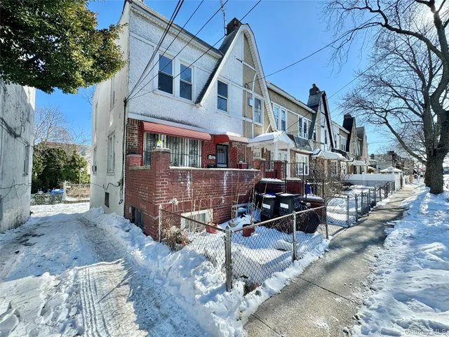 a view of a building with a bench in a backyard