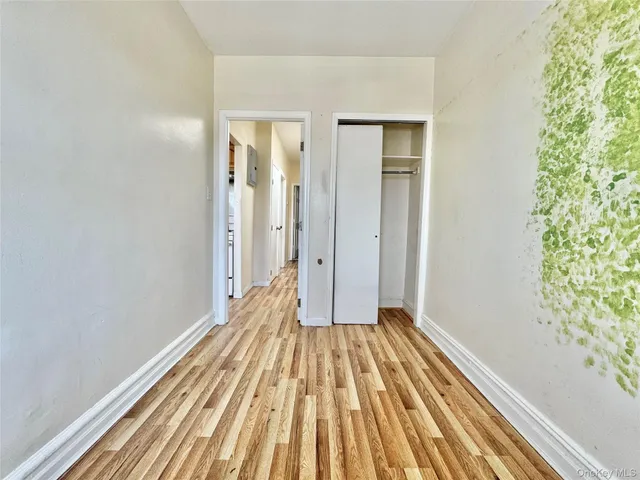 a view of a room with wooden floor and bench