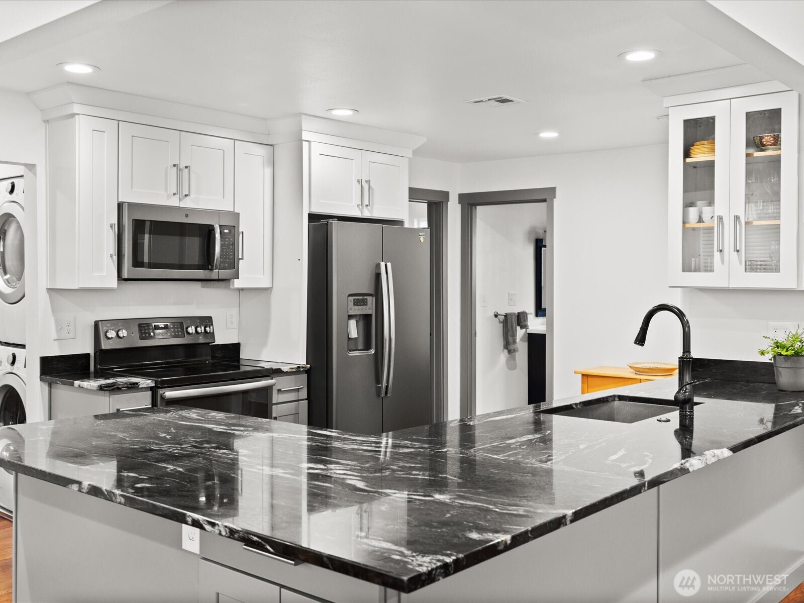 10126 Northeast 186th Street Bothell, WA 98011 - Photo 24 of 40 a kitchen with stainless steel appliances granite countertop a sink a stove and a refrigerator