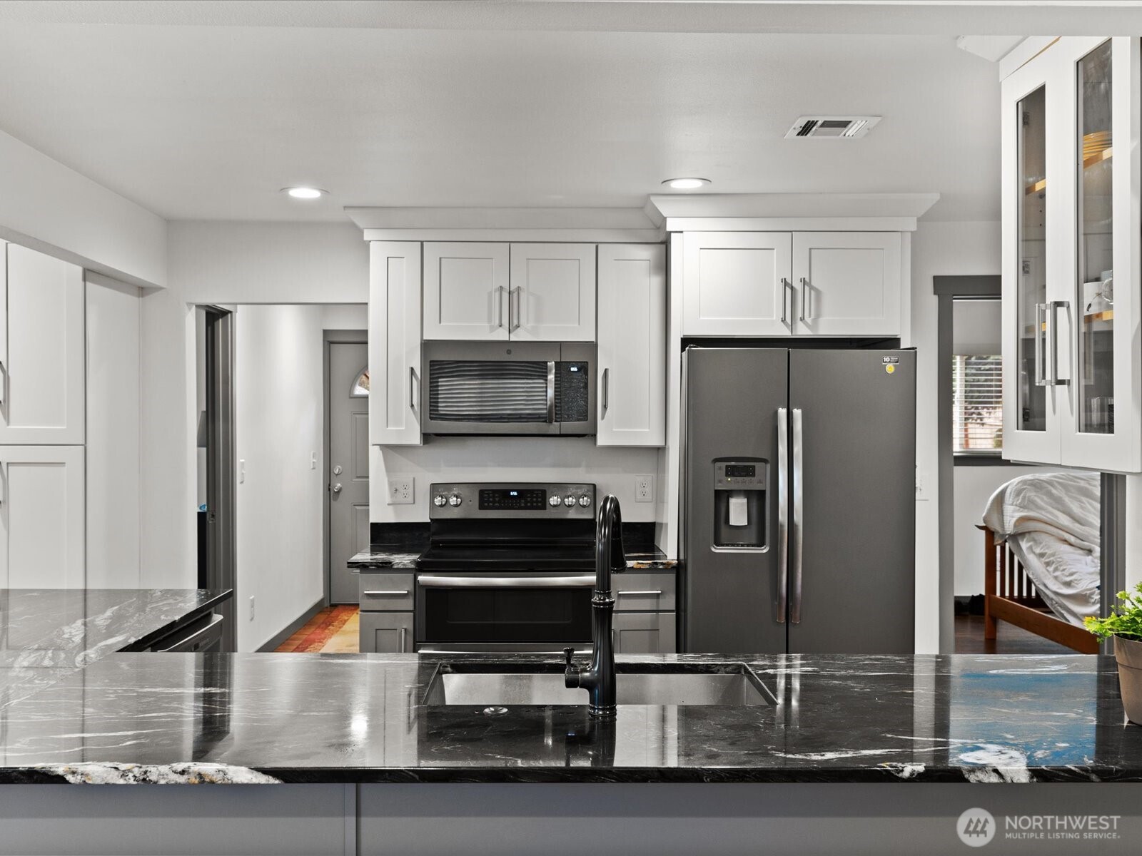 10126 Northeast 186th Street Bothell, WA 98011 - Photo 25 of 40 a kitchen with stainless steel appliances granite countertop a refrigerator and a stove top oven