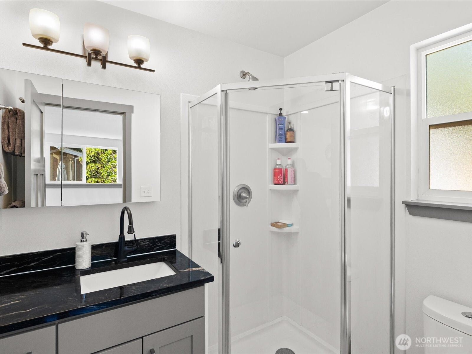 10126 Northeast 186th Street Bothell, WA 98011 - Photo 31 of 40 a bathroom with a shower sink and mirror