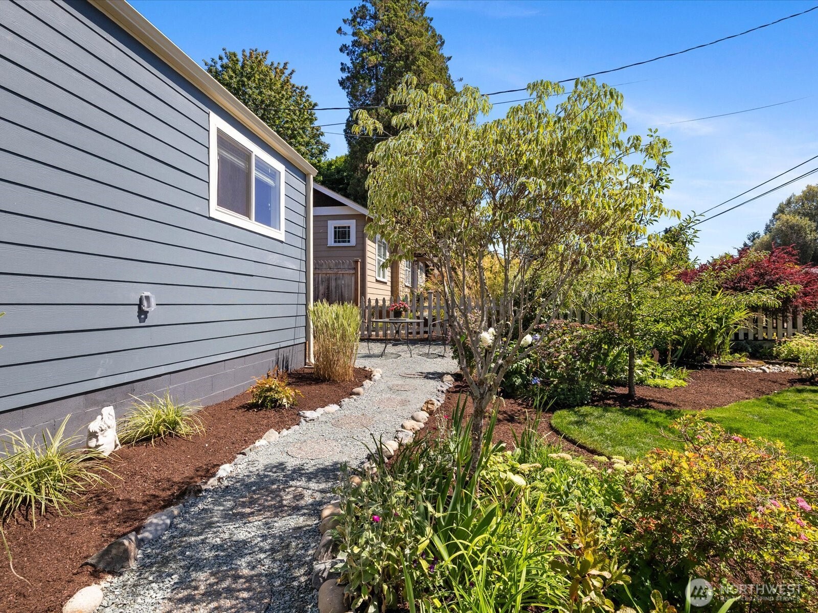 10126 Northeast 186th Street Bothell, WA 98011 - Photo 7 of 40 a view of a backyard with potted plants and large tree