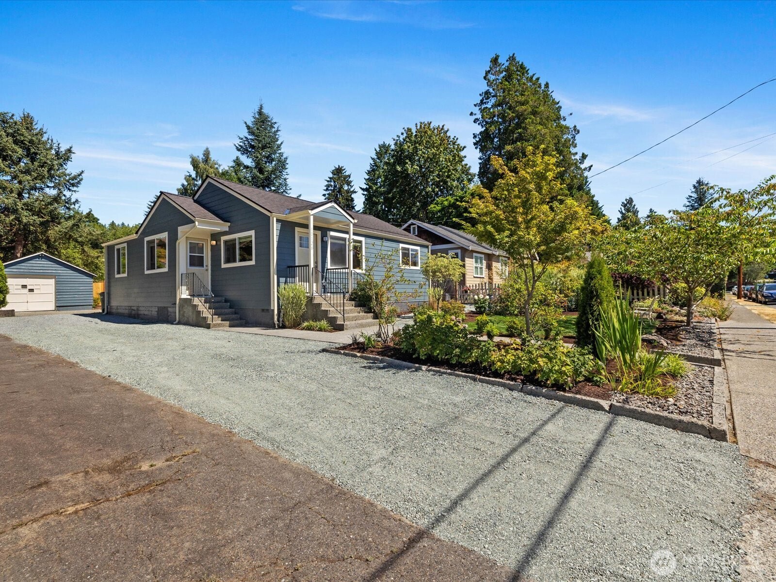 10126 Northeast 186th Street Bothell, WA 98011 - Photo 9 of 40 a front view of a house with a yard and potted plants