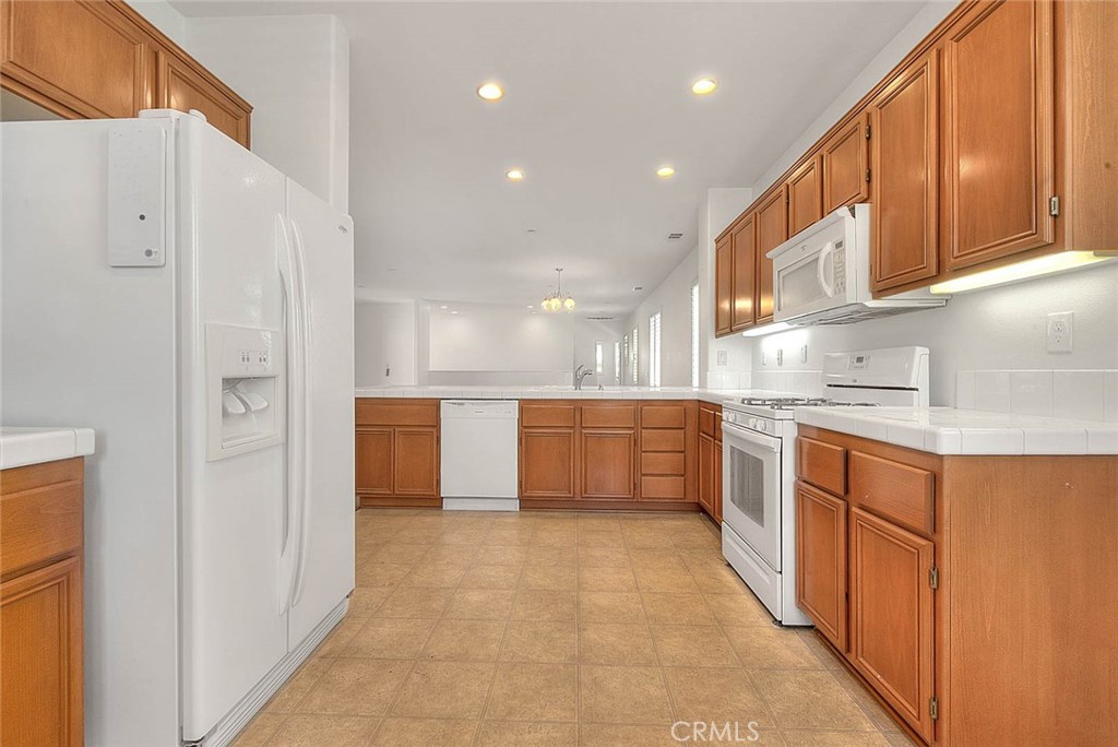 8150 West Preserve Loop Chino, CA 91708 - Photo 25 of 51 a kitchen with stainless steel appliances granite countertop a refrigerator and a sink