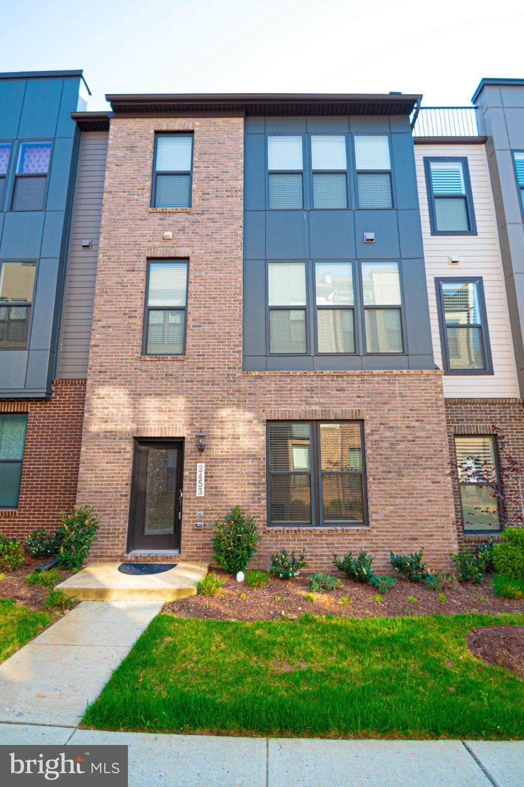 2453 Liberty Loop Herndon, VA 20171 - Photo 2 of 52 a brick building with a yard in front of it