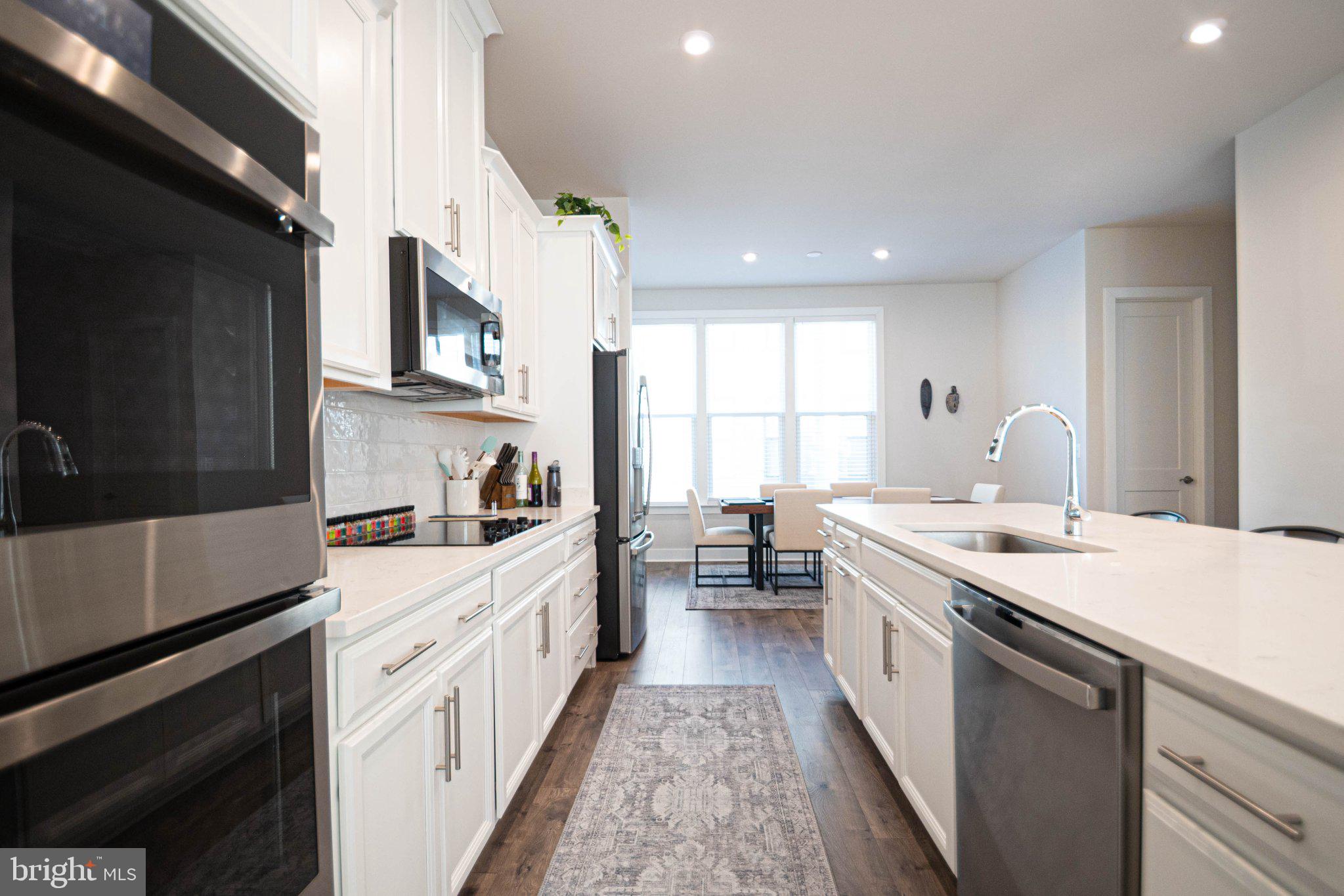 2453 Liberty Loop Herndon, VA 20171 - Photo 22 of 52 a kitchen with a sink stove and cabinets