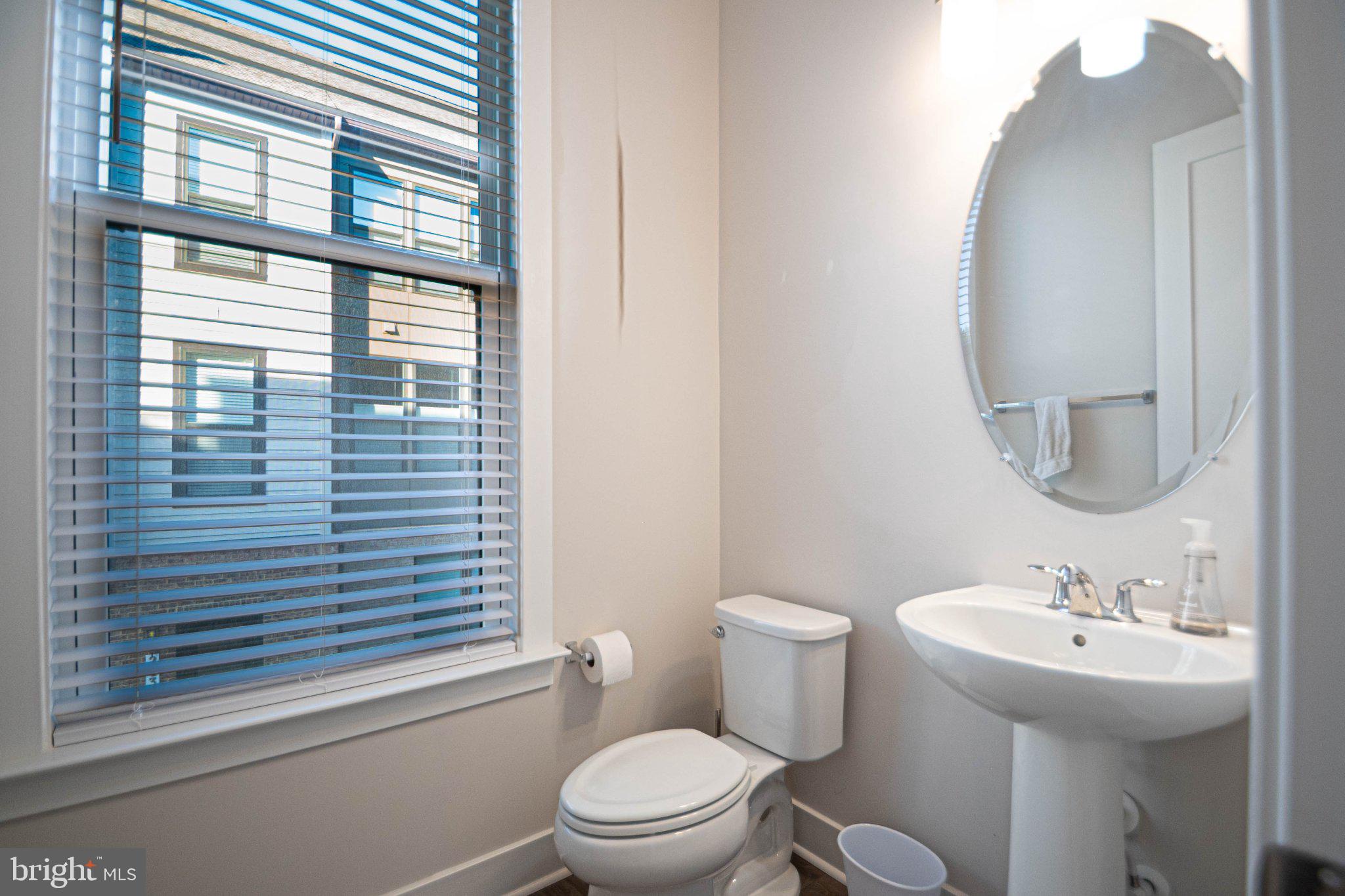 2453 Liberty Loop Herndon, VA 20171 - Photo 26 of 52 a bathroom with a sink a mirror and a toilet