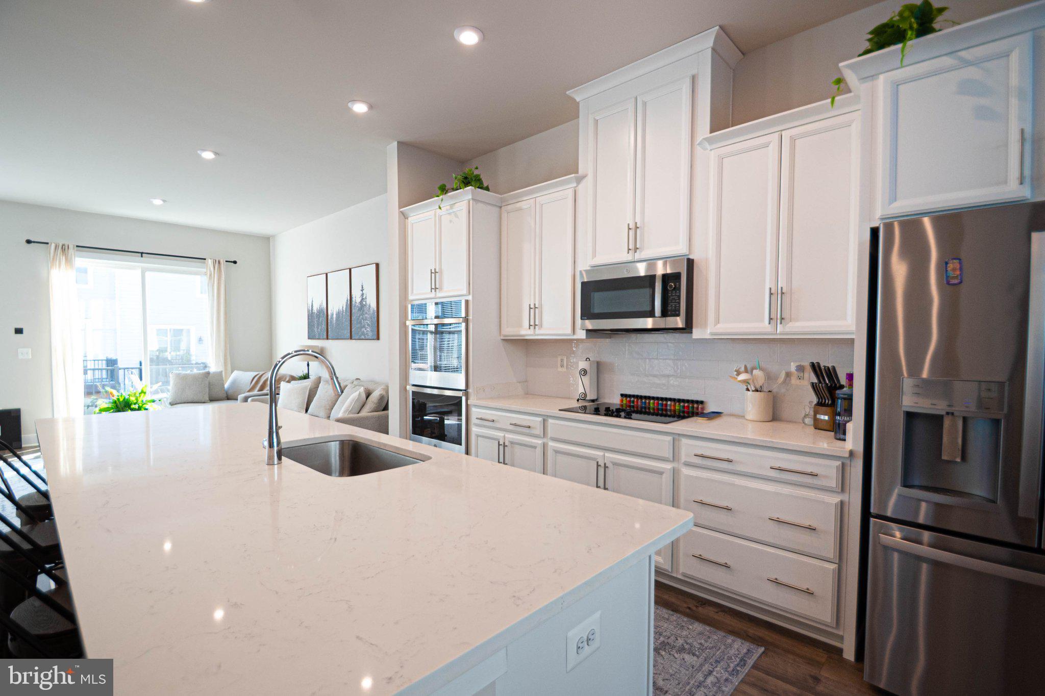 2453 Liberty Loop Herndon, VA 20171 - Photo 32 of 52 a kitchen with stainless steel appliances a refrigerator sink and microwave