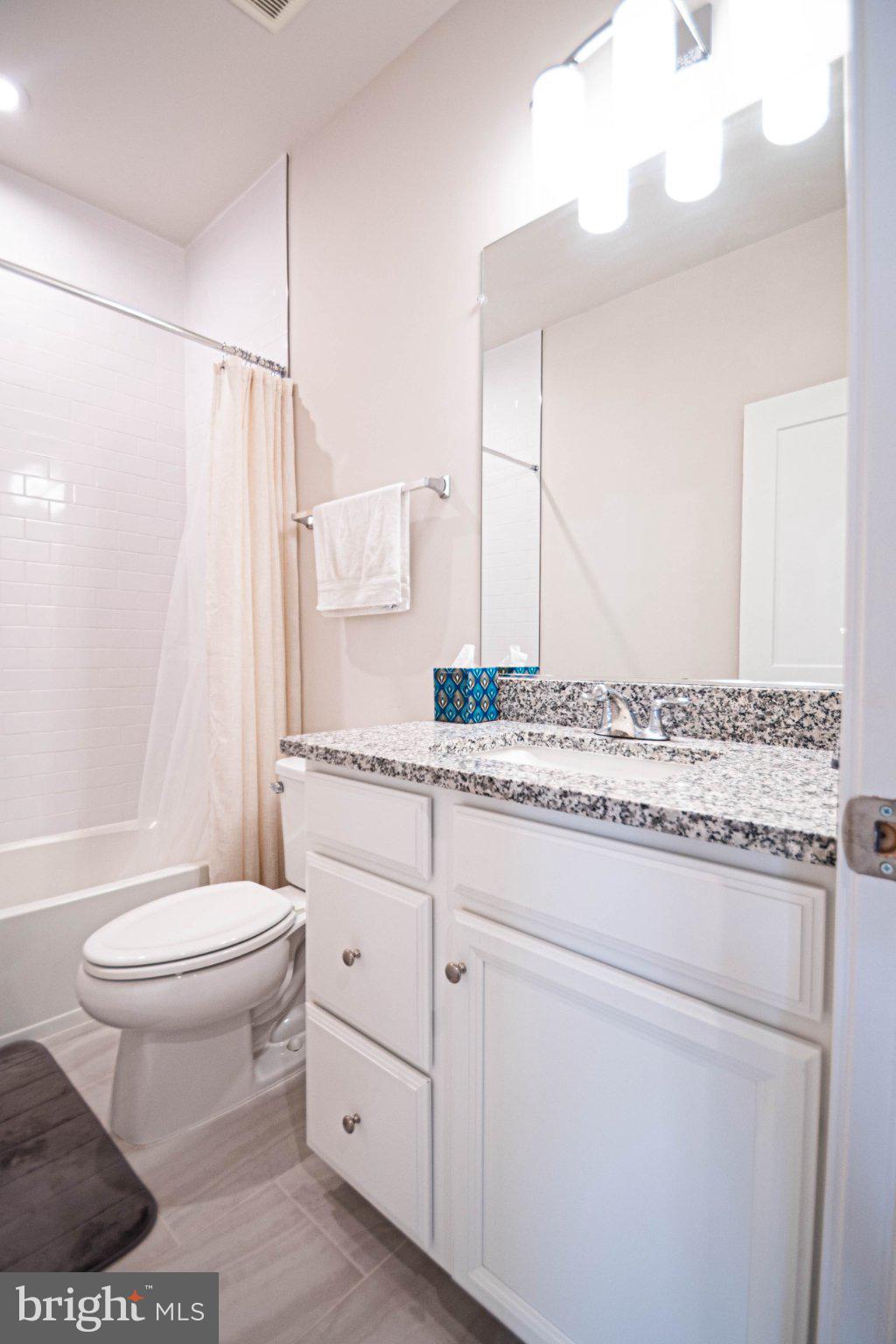 2453 Liberty Loop Herndon, VA 20171 - Photo 34 of 52 a bathroom with a granite countertop sink toilet and shower