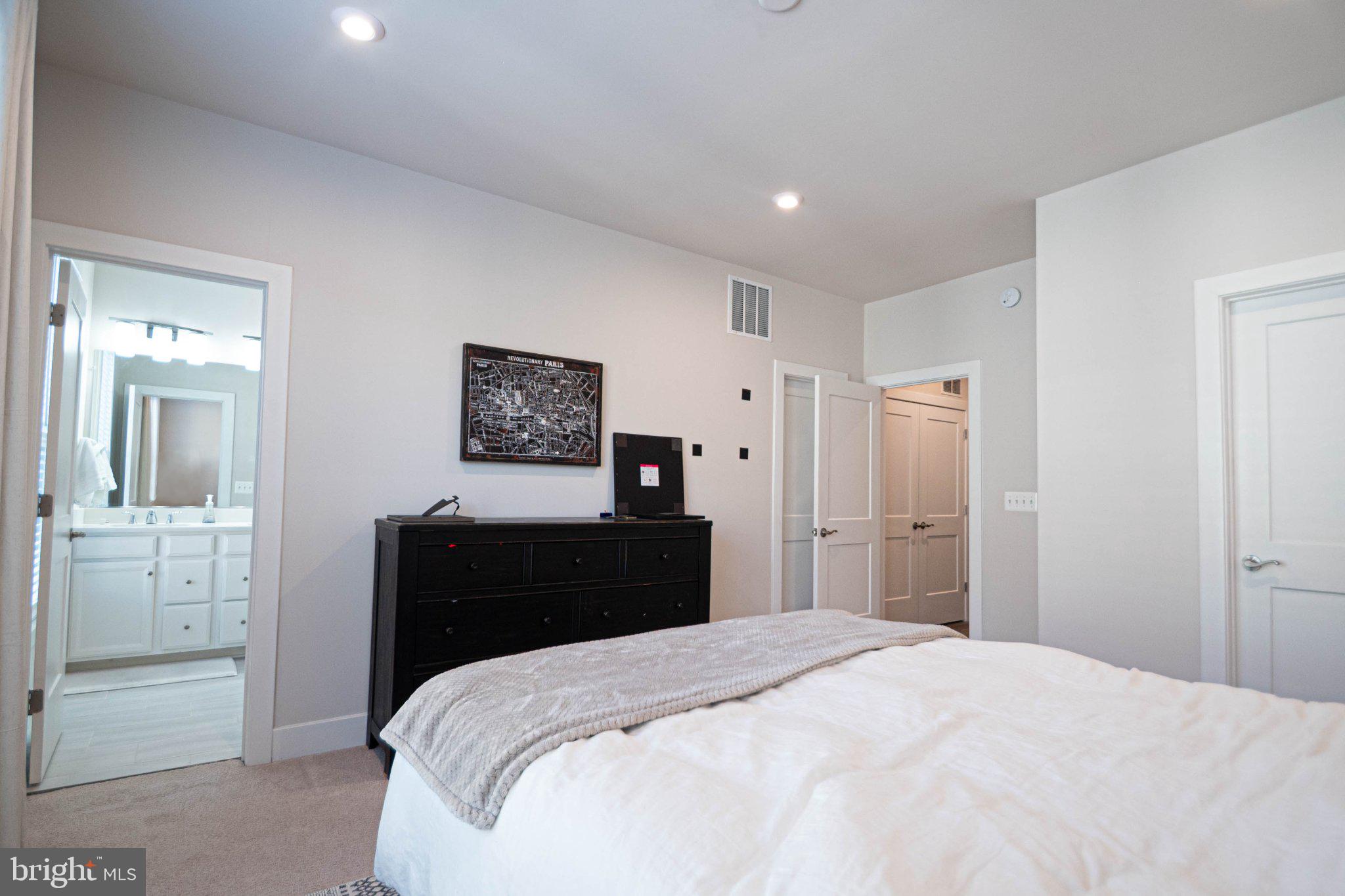 2453 Liberty Loop Herndon, VA 20171 - Photo 46 of 52 a bedroom with a bed and mirror