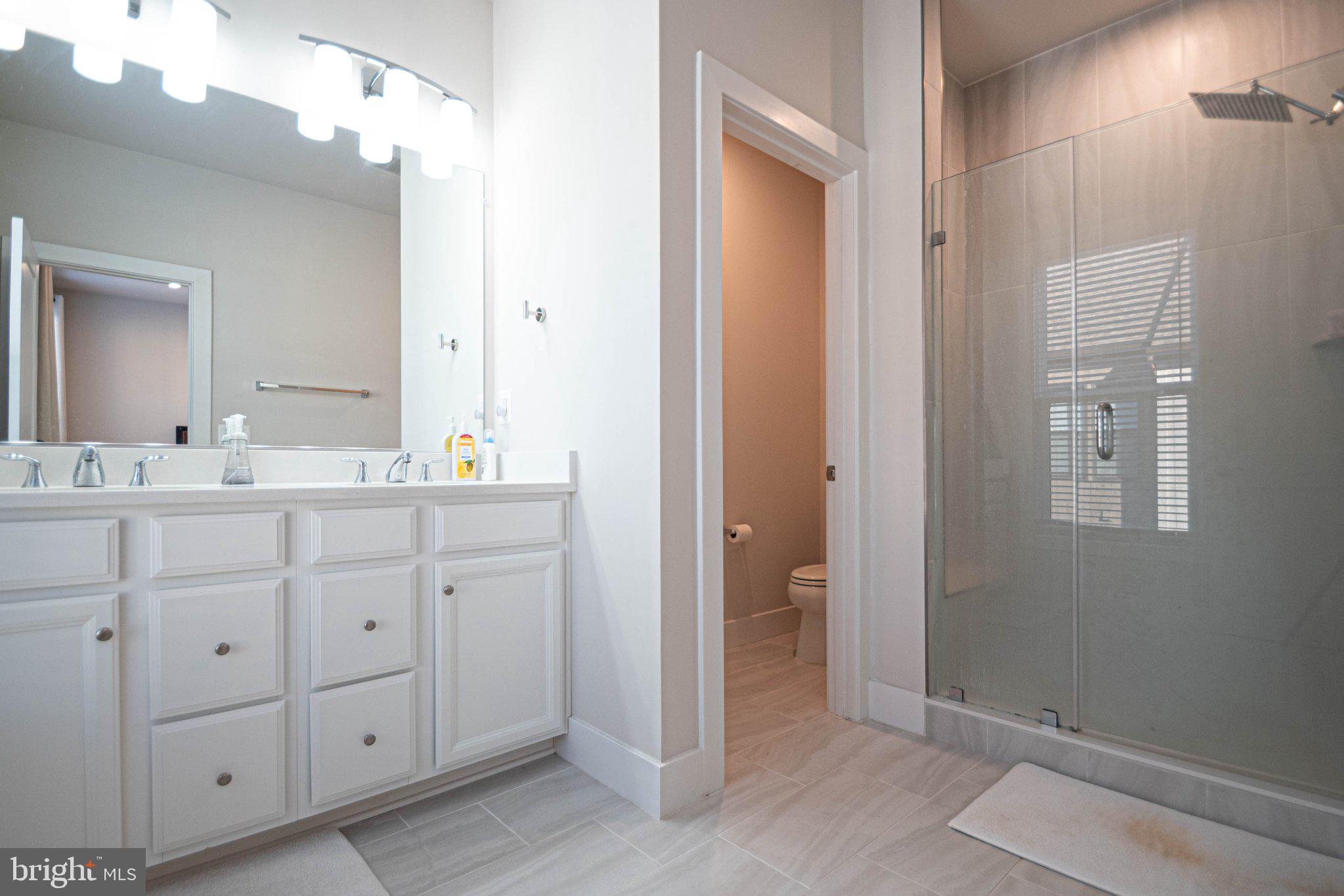 2453 Liberty Loop Herndon, VA 20171 - Photo 48 of 52 a bathroom with a double vanity sink and mirror