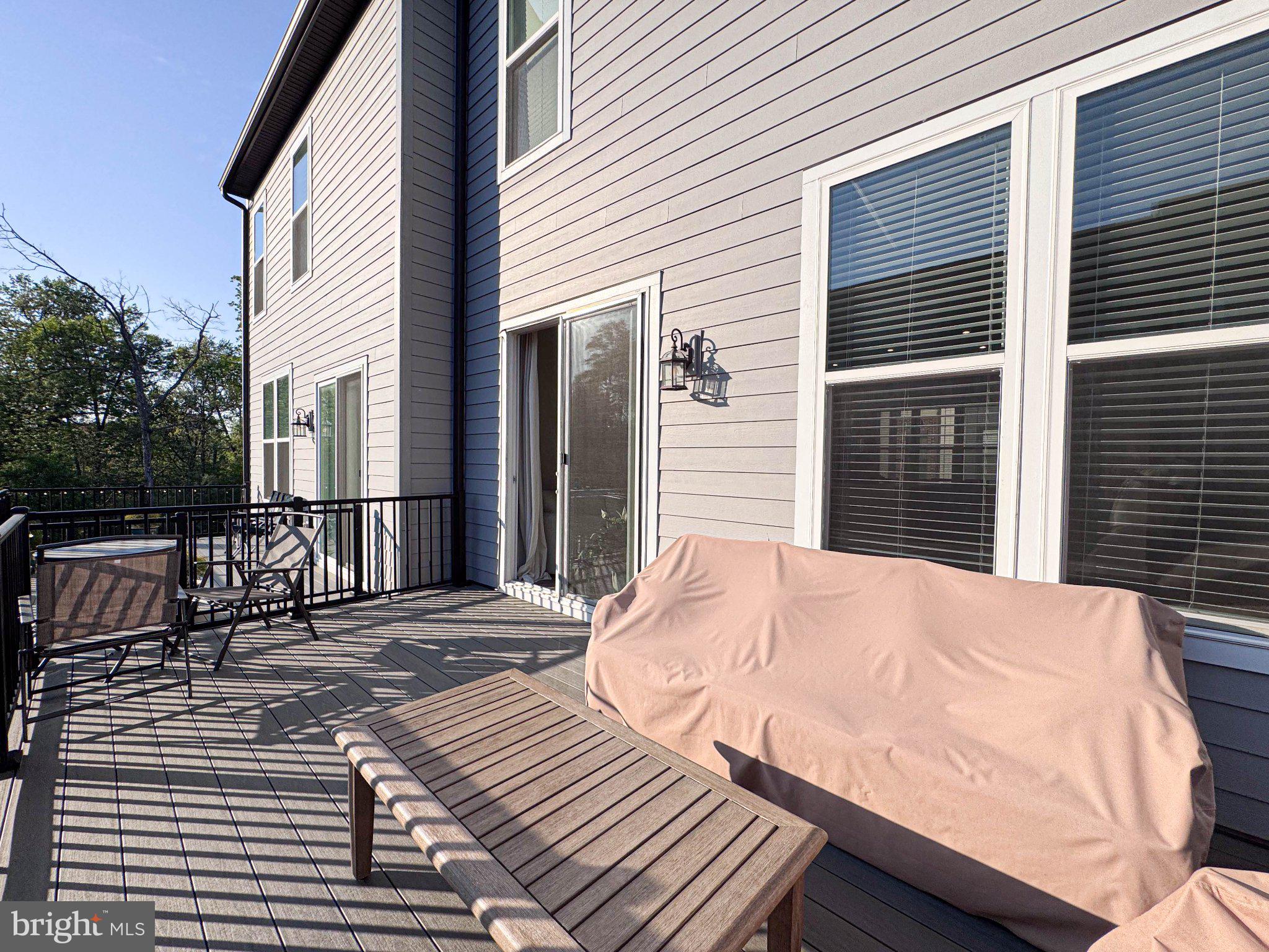 2453 Liberty Loop Herndon, VA 20171 - Photo 51 of 52 a balcony with wooden floor table and chairs