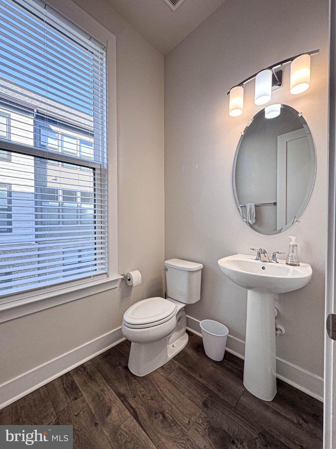 2453 Liberty Loop Herndon, VA 20171 - Photo 9 of 52 a bathroom with a toilet a sink and a mirror