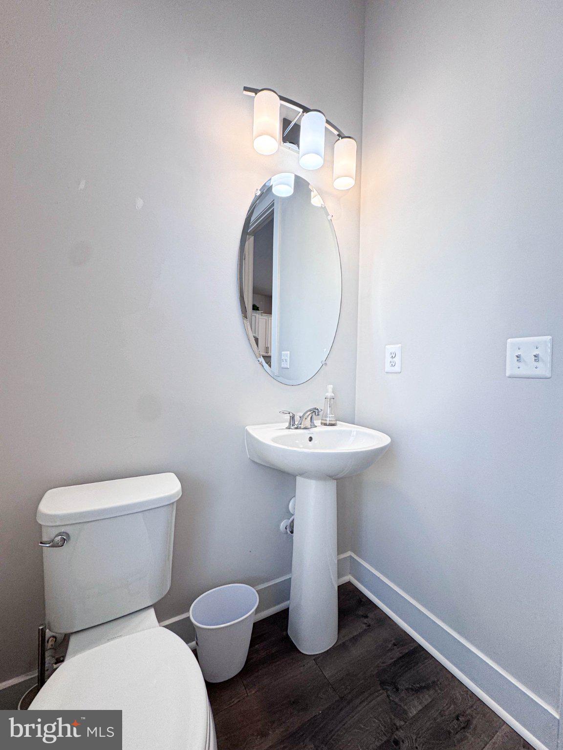 2453 Liberty Loop Herndon, VA 20171 - Photo 10 of 52 a bathroom with a toilet sink and mirror