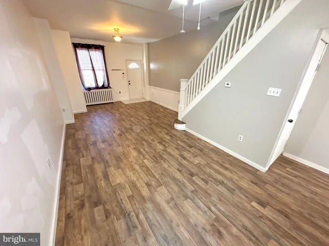 an entryway in a hallway with wooden floor