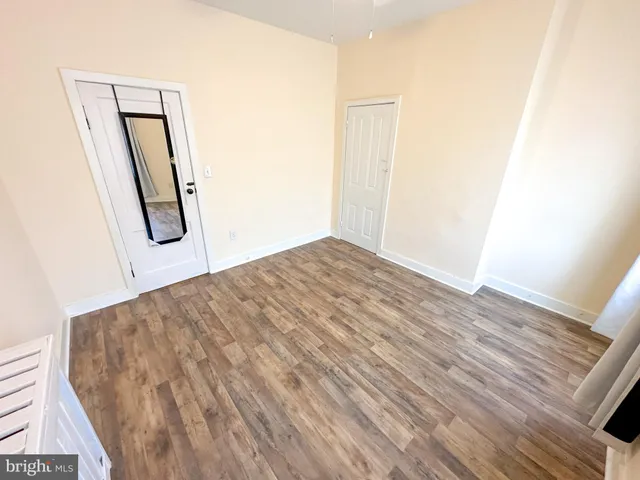 a view of an empty room and wooden floor