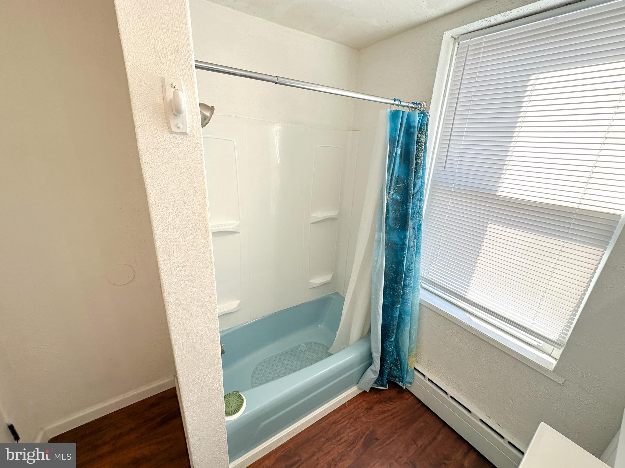 2834 East Venango Street Philadelphia, PA 19134 - Photo 8 of 14 a bathroom with a glass door shower and a window