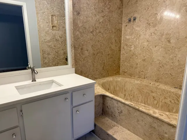 a bathroom with a sink toilet and a mirror