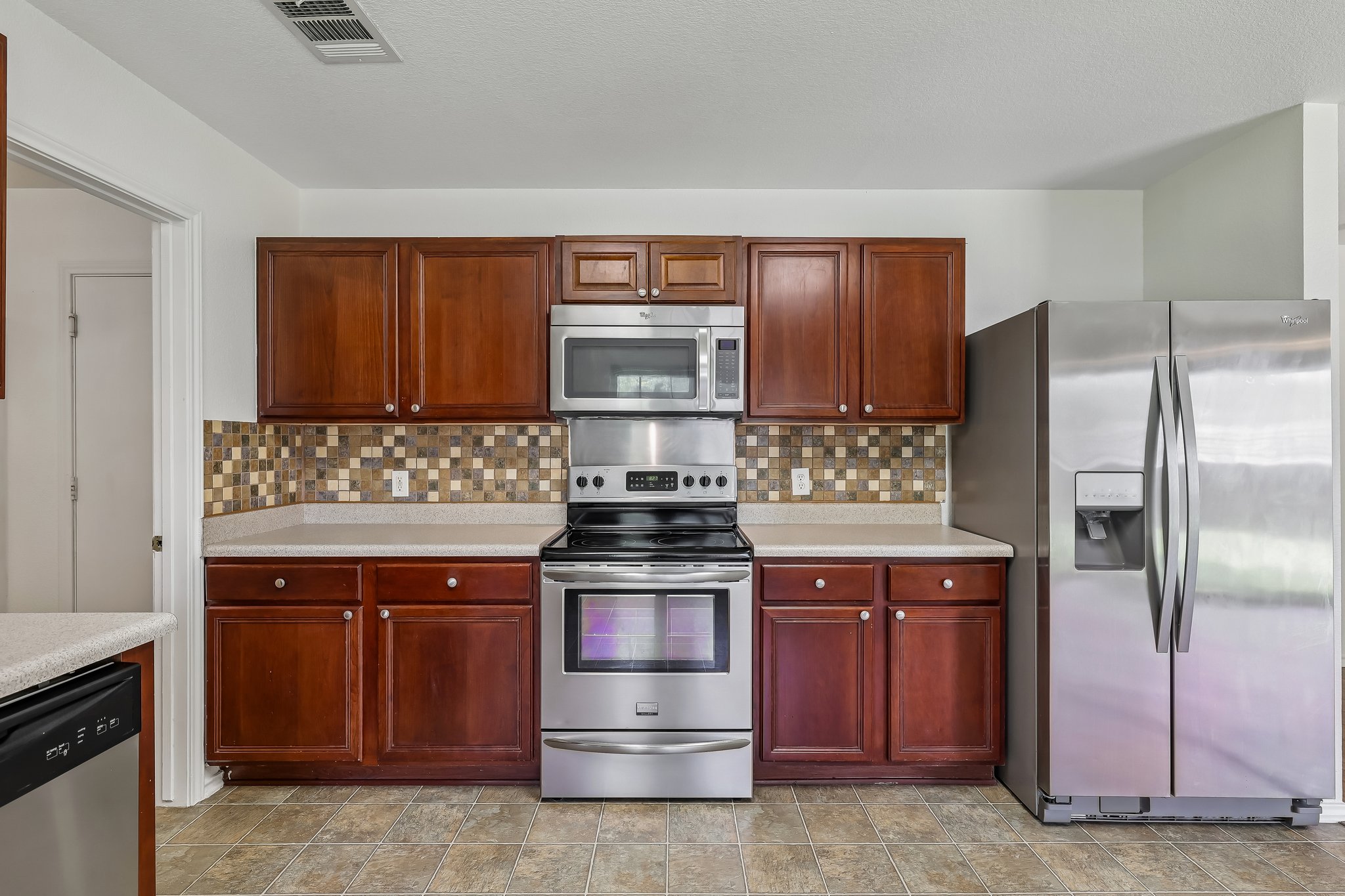 7658 Marble Ridge Drive Austin, TX 78747 - Photo 12 of 34 a kitchen with a stove and a refrigerator
