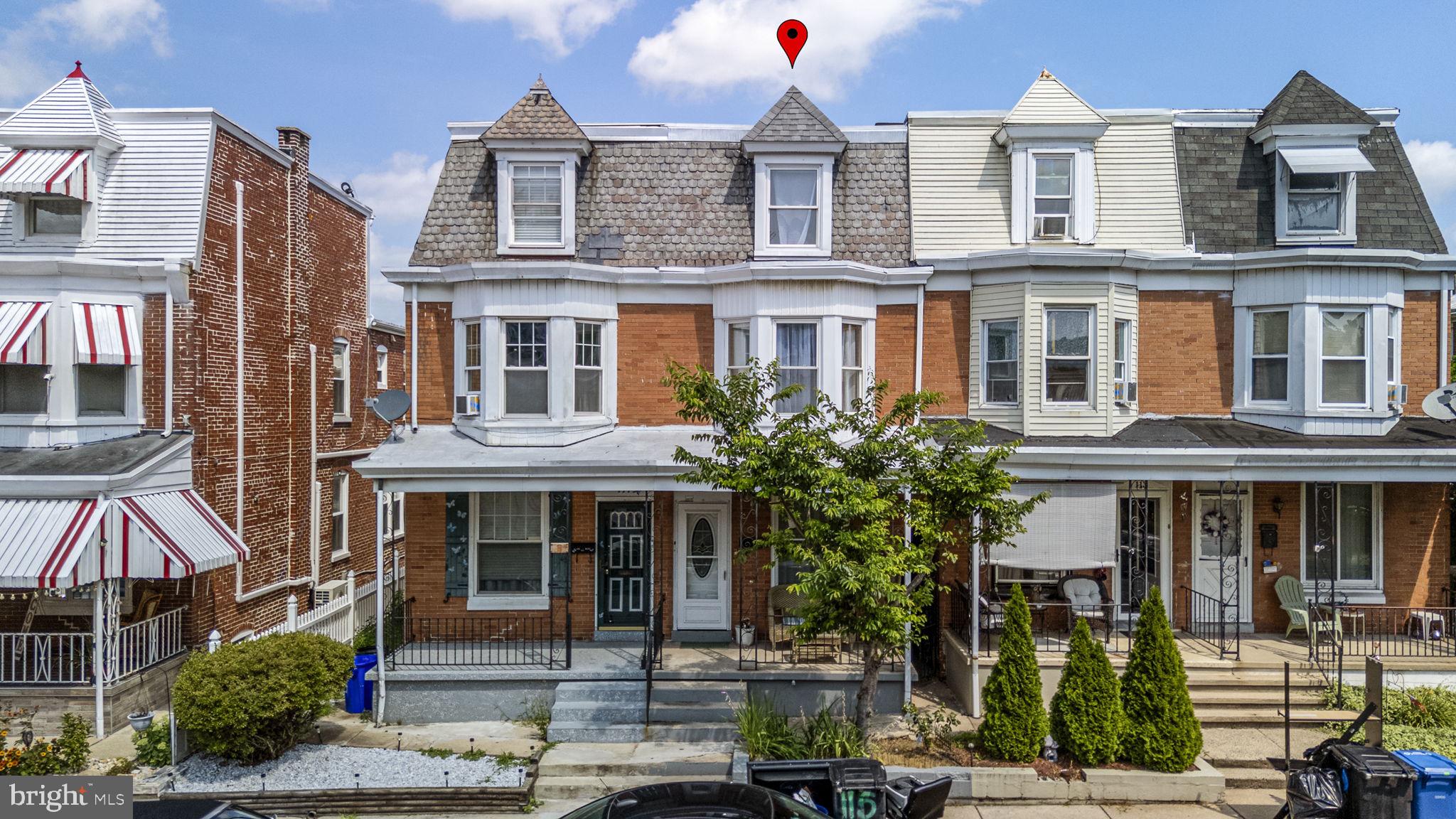 a front view of a residential apartment building with a yard