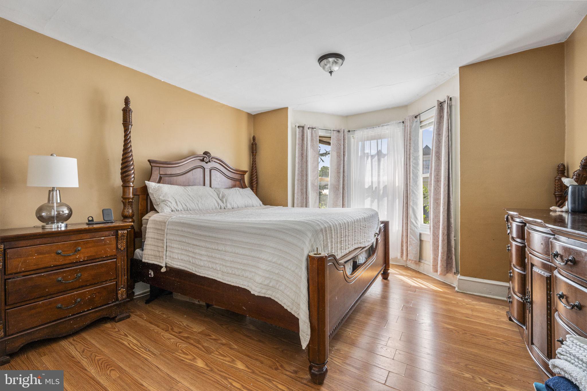 115 Park Avenue Reading, PA 19605 - Photo 13 of 28 a spacious bedroom with a bed and a dresser in it