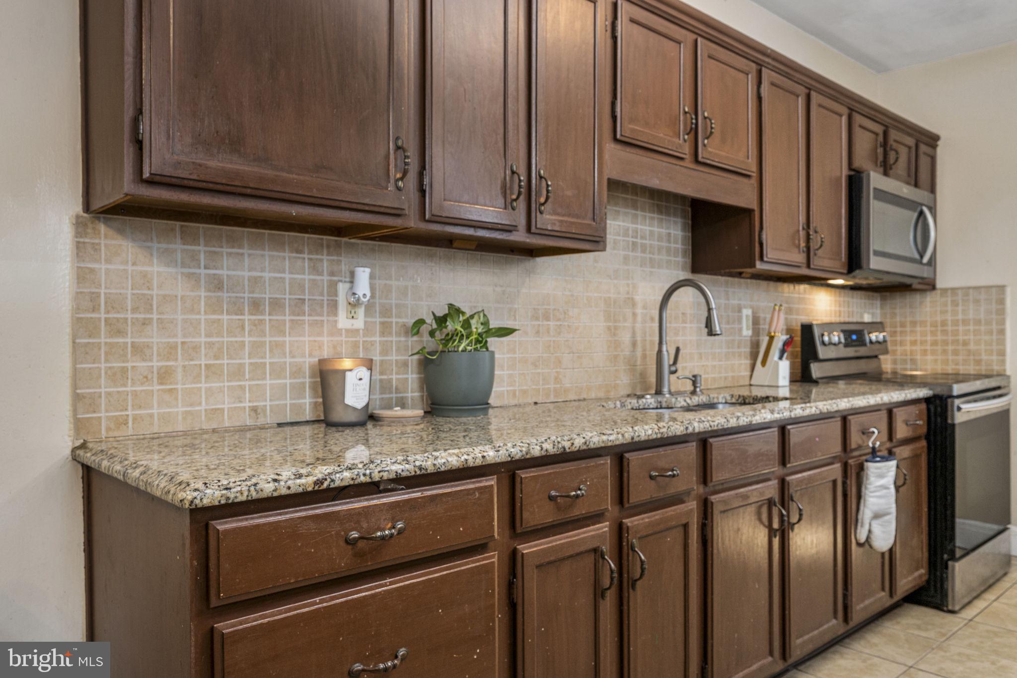 115 Park Avenue Reading, PA 19605 - Photo 10 of 28 a kitchen with stainless steel appliances granite countertop a sink stove and cabinets
