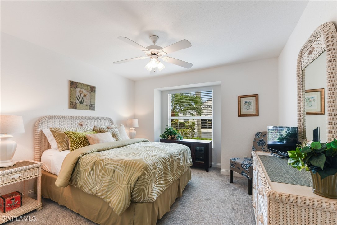 512 Islamorada Boulevard Punta Gorda, FL 33955 - Photo 27 of 46 a bedroom with a bed and a chandelier
