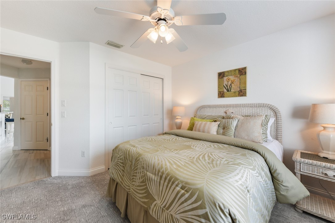 512 Islamorada Boulevard Punta Gorda, FL 33955 - Photo 29 of 46 a bedroom with a bed and a chandelier